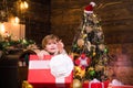 Happy child with Christmas gift. Portrait of Santa kid with huge red gift looking at camera. Kid having fun near Royalty Free Stock Photo