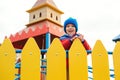 Happy child on colorful castle playground. Cute little boy playing outdoors in cold autumn time. Happy and healthy childhood. Royalty Free Stock Photo