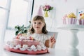 happy child in cone doing idea gesture at table with birthday