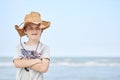 Happy child with a cowboy leather hat letting himself be photographed with the sea in the background..Close-up of a smiling child Royalty Free Stock Photo