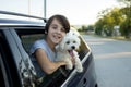 Happy child, cute boy, looking out of the window of a car with his pet dog Royalty Free Stock Photo