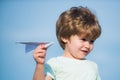 Happy child. Cute boy with paper aipplene. Happy kid on summer field - dream of flying concept. Family travel and Royalty Free Stock Photo
