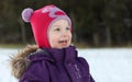 A happy child with a cute hat out in the snow Royalty Free Stock Photo