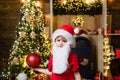 Happy child decorating Christmas tree. Happy little child dressed in winter clothing think about Santa near Christmas Royalty Free Stock Photo