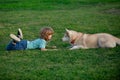 Happy child and dog on grass. Cute boy child with dog relaxing on park. Fun games with pet on summer vacation. Husky dog Royalty Free Stock Photo