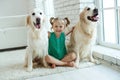 Happy child with a dog. Portrait of a girl with a pet. Labrador Retriever at home. Royalty Free Stock Photo