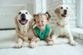 Happy child with a dog. Portrait of a girl with a pet. Labrador Retriever at home. Royalty Free Stock Photo