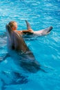 Happy child and dolphins in blue water. Dolphin Assisted Therapy Royalty Free Stock Photo