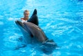 Happy child and dolphins in blue water. Dolphin Assisted Therapy Royalty Free Stock Photo