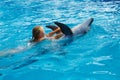 Happy child and dolphins in blue water. Dolphin Assisted Therapy Royalty Free Stock Photo