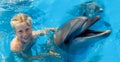 Happy child and dolphins in blue water. Dolphin Assisted Royalty Free Stock Photo