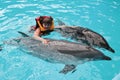 Happy child and dolphins in blue water. Dolphin Assisted Therapy Royalty Free Stock Photo