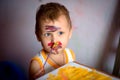 Happy child draws with colorful paints. Portrait of a child with a painted face Royalty Free Stock Photo