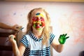 Happy child draws with colorful paints. Portrait of a child with a painted face Royalty Free Stock Photo