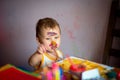 Happy child draws with colorful paints. Portrait of a child with a painted face Royalty Free Stock Photo