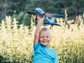 Happy child dreams of traveling and playing with an airplane