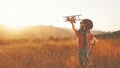 happy child dreams of traveling and playing with an airplane pilot aviator in outdoor Royalty Free Stock Photo