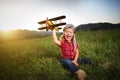 happy child dreams of traveling and playing with an airplane pilot aviator in outdoor Royalty Free Stock Photo