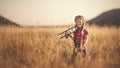 happy child dreams of traveling and playing with an airplane pilot aviator in outdoor Royalty Free Stock Photo