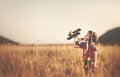 happy child dreams of traveling and playing with an airplane pilot aviator in outdoor Royalty Free Stock Photo