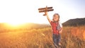 happy child dreams of traveling and playing with an airplane pilot aviator in outdoor Royalty Free Stock Photo