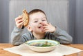 Happy child eating bread for dinner Royalty Free Stock Photo