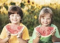 Happy child eating watermelon in garden. Two boys with fruit in park Royalty Free Stock Photo