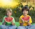 Happy child eating watermelon in garden. Two boys with fruit in park Royalty Free Stock Photo