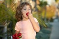 Happy child eats strawberries. Cute little boy holding a strawberry. Royalty Free Stock Photo