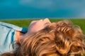 Happy child enjoying on grass field and dreaming. Kid relax on nature. Summer dream. Kid dreams on grass. Childhood Royalty Free Stock Photo