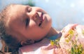 Happy child enjoying nature outdoors. Springtime. Portrait one smiling girl with closed eyes. Beautiful day dreaming little girl Royalty Free Stock Photo