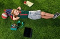 Happy child enjoying in park during summer and autumn day in nature on green grass with school supplies outdoor. Top Royalty Free Stock Photo