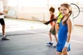 Happy child enjoying tennis game with her group Royalty Free Stock Photo