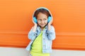 Happy child enjoys listens to music in headphones Royalty Free Stock Photo