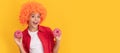 happy child in fancy orange wig hair hold sweet glazed donut, happiness. Teenager child with sweets, poster banner