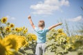 Happy child field Freedom and happiness concept on sunflower outdoor. Kid having fun in green spring field against blue sky Royalty Free Stock Photo
