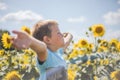 Happy child field Freedom and happiness concept on sunflower outdoor. Kid having fun in green spring field against blue sky Royalty Free Stock Photo