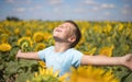 Happy child field Freedom and happiness concept on sunflower outdoor. Kid having fun in green spring field against blue sky Royalty Free Stock Photo