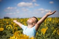 Happy child field Freedom and happiness concept on sunflower outdoor. Kid having fun in green spring field against blue sky Royalty Free Stock Photo