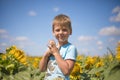 Happy child field Freedom and happiness concept on sunflower outdoor. Kid having fun in green spring field against blue sky Royalty Free Stock Photo