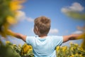 Happy child field Freedom and happiness concept on sunflower outdoor. Kid having fun in green spring field against blue sky Royalty Free Stock Photo