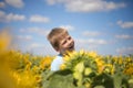 Happy child field Freedom and happiness concept on sunflower outdoor. Kid having fun in green spring field against blue sky Royalty Free Stock Photo