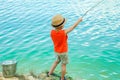 Happy child fishes off the coast in nature Royalty Free Stock Photo