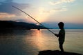 happy child fishing by the sea silhouette