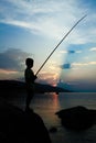 happy child fishing by the sea silhouette