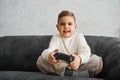 Happy child with gamepad at home. Boy is playing games. Royalty Free Stock Photo