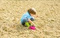 Happy child gardener. botanic worker. Spring. earth day. new life. summer farm. small kid planting a flower. ecology