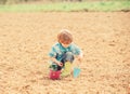 Happy child gardener. spring country side village. earth day. soils and fertilizers. summer farm. small kid planting a Royalty Free Stock Photo