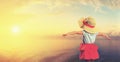 Happy child girl admiring sunset on beach Royalty Free Stock Photo