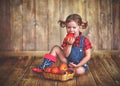 Happy child girl with a basket of peaches Royalty Free Stock Photo